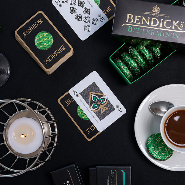 Bendicks Mints on a table with playing cards and drinks